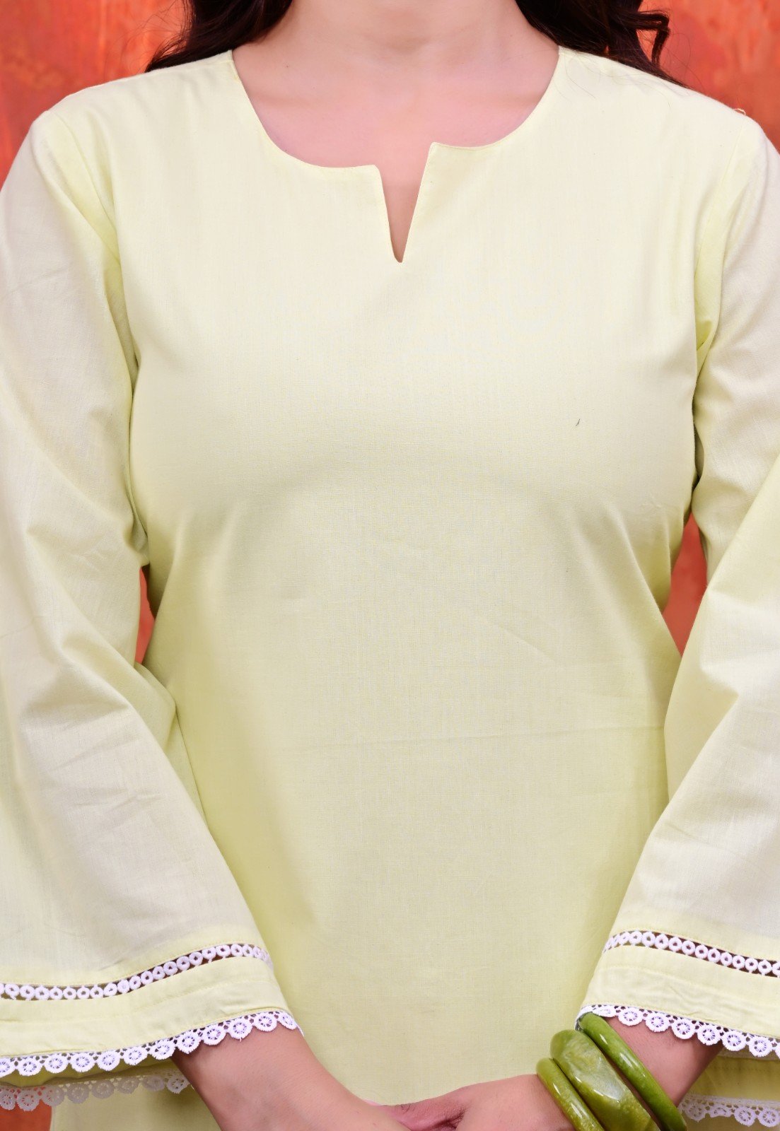 Women Plain Lime Cotton Short Kurti with Flared Sleeves Paired with White Patiala Salwar